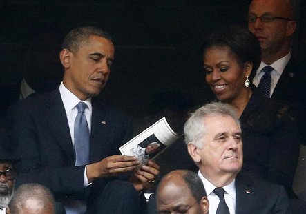 U.S. President Barack Obama (back L) and his wife, first lady Michelle Obama look at the official program booklet during the memorial servic U.S. President Barack Obama (back L) and his wife, first lady Michelle Obama look at the official program booklet during the memorial servic