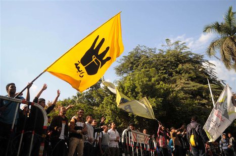 Students of Cairo University, who are supporters of the Muslim Brotherhood and ousted Egyptian President Mohamed Mursi, wave a flag bearing Students of Cairo University, who are supporters of the Muslim Brotherhood and ousted Egyptian President Mohamed Mursi, wave a flag bearing