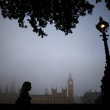 A woman walks along the south bank of the Thames opposite the Houses of Parliament on a foggy morning in London September 24, 2013. REUTERS/ A woman walks along the south bank of the Thames opposite the Houses of Parliament on a foggy morning in London September 24, 2013. REUTERS/