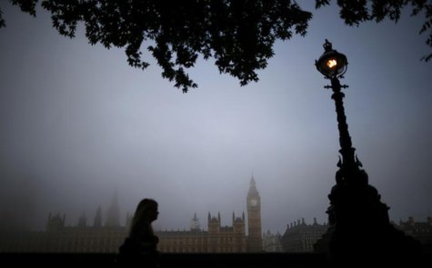 A woman walks along the south bank of the Thames opposite the Houses of Parliament on a foggy morning in London September 24, 2013. REUTERS/ A woman walks along the south bank of the Thames opposite the Houses of Parliament on a foggy morning in London September 24, 2013. REUTERS/
