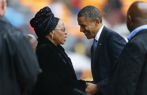 U.S. President Barack Obama (2nd R) pays his respect to former South African President Nelson Mandela's widow Graca Machel (2nd L) after his U.S. President Barack Obama (2nd R) pays his respect to former South African President Nelson Mandela's widow Graca Machel (2nd L) after his
