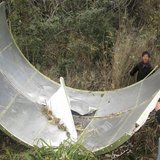 Members of a local militia collect a component of the Long March 4B rocket, which was loaded with a CBERS-3 satellite, after it was found in Members of a local militia collect a component of the Long March 4B rocket, which was loaded with a CBERS-3 satellite, after it was found in