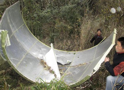 Members of a local militia collect a component of the Long March 4B rocket, which was loaded with a CBERS-3 satellite, after it was found in Members of a local militia collect a component of the Long March 4B rocket, which was loaded with a CBERS-3 satellite, after it was found in