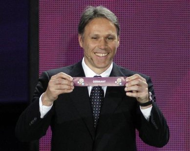 Former Dutch player Marco van Basten draws Germany during the draw of the Euro 2012 soccer championship at the Palace of Arts in Kiev Decemb Former Dutch player Marco van Basten draws Germany during the draw of the Euro 2012 soccer championship at the Palace of Arts in Kiev Decemb
