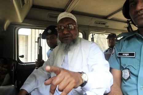 Bangladesh's Jamaat-e-Islami leader Abdul Quader Mollah gestures as he talks from a police van after a war crimes tribunal sentenced him to Bangladesh's Jamaat-e-Islami leader Abdul Quader Mollah gestures as he talks from a police van after a war crimes tribunal sentenced him to