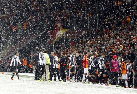 Players of Galatasaray and Juventus walk out of the pitch as their match is paused for 20 minutes due a heavy snowfall during their Champion Players of Galatasaray and Juventus walk out of the pitch as their match is paused for 20 minutes due a heavy snowfall during their Champion