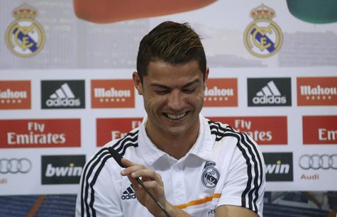 Real Madrid's Cristiano Ronaldo reacts as he attends a news conference to discuss the draw for the 2014 World Cup at the Valdebebas training Real Madrid's Cristiano Ronaldo reacts as he attends a news conference to discuss the draw for the 2014 World Cup at the Valdebebas training