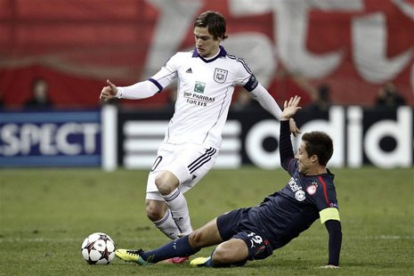 Olympiakos' David Fuster (R) tackles Anderlecht's Guillaume Gillet during their Champions League Group C soccer match at Karaiskaki stadium Olympiakos' David Fuster (R) tackles Anderlecht's Guillaume Gillet during their Champions League Group C soccer match at Karaiskaki stadium