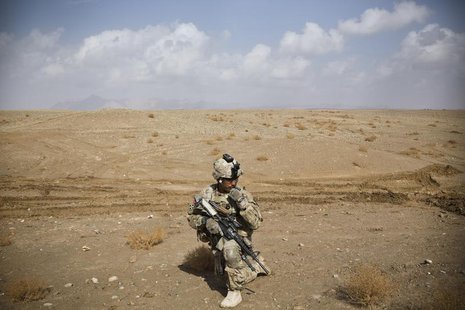 A U.S. Army soldier with Charlie Company, 36th Infantry Regiment, 1st Armored Division sets up at a supportive position during a mission nea A U.S. Army soldier with Charlie Company, 36th Infantry Regiment, 1st Armored Division sets up at a supportive position during a mission nea