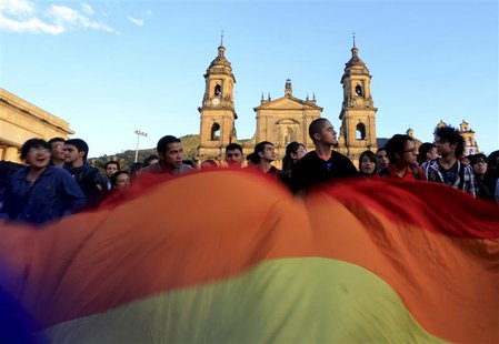 Supporters of Bogota's mayor Gustavo Petro wave an LGBT flag during a protest against his removal at Bogota's Bolivar Square December 10, 20 Supporters of Bogota's mayor Gustavo Petro wave an LGBT flag during a protest against his removal at Bogota's Bolivar Square December 10, 20