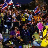 Anti-government protesters dance as they wait for their leader Suthep Thaugsuban to address them from the stage near the Government house in Anti-government protesters dance as they wait for their leader Suthep Thaugsuban to address them from the stage near the Government house in