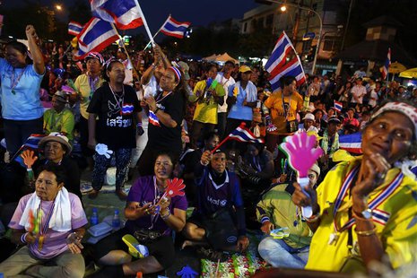 Anti-government protesters dance as they wait for their leader Suthep Thaugsuban to address them from the stage near the Government house in Anti-government protesters dance as they wait for their leader Suthep Thaugsuban to address them from the stage near the Government house in