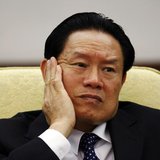 Then China's Public Security Minister Zhou Yongkang reacts as he attends the Hebei delegation discussion sessions at the 17th National Congr Then China's Public Security Minister Zhou Yongkang reacts as he attends the Hebei delegation discussion sessions at the 17th National Congr