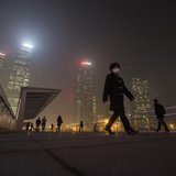 A man wears a mask while walking on a bridge during a hazy night in Shanghai's financial district of Pudong December 5, 2013. REUTERS/Aly So A man wears a mask while walking on a bridge during a hazy night in Shanghai's financial district of Pudong December 5, 2013. REUTERS/Aly So