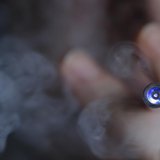 A man uses an E-cigarette, an electronic substitute in the form of a rod, slightly longer than a normal cigarette, in this illustration pict A man uses an E-cigarette, an electronic substitute in the form of a rod, slightly longer than a normal cigarette, in this illustration pict
