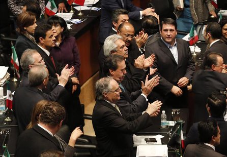 Senators of the ruling Institutional Revolutionary Party (PRI) applaud after Mexico's Senate signed off on an energy bill at the Senate buil Senators of the ruling Institutional Revolutionary Party (PRI) applaud after Mexico's Senate signed off on an energy bill at the Senate buil