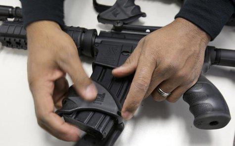 A New Haven police officer dismantles a Bushmaster semi-automatic assault rifle after it was turned in during a gun buyback event at the New A New Haven police officer dismantles a Bushmaster semi-automatic assault rifle after it was turned in during a gun buyback event at the New