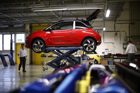 Workers are pictured next to an Opel Adam car during the start of the car production in Eisenach January 10, 2013. REUTERS/Lisi Niesner Workers are pictured next to an Opel Adam car during the start of the car production in Eisenach January 10, 2013. REUTERS/Lisi Niesner