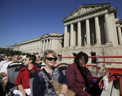 Tourists, with guide Darnell Lacy (R), pass by the closed National Archives building in Washington atop a Big Bus double-decker tour bus. RE Tourists, with guide Darnell Lacy (R), pass by the closed National Archives building in Washington atop a Big Bus double-decker tour bus. RE