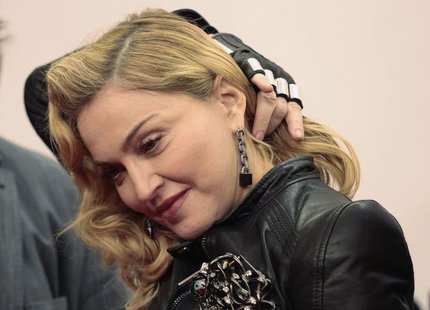 U.S. singer Madonna arrives to promote her latest gym in her Hard Candy Fitness centre chain in Berlin October 17, 2013. REUTERS/Tobias Schw U.S. singer Madonna arrives to promote her latest gym in her Hard Candy Fitness centre chain in Berlin October 17, 2013. REUTERS/Tobias Schw