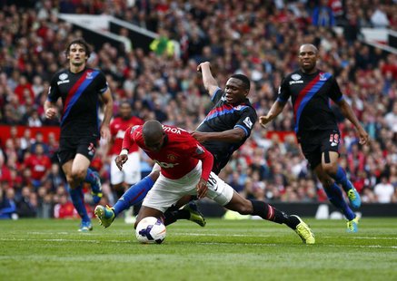 Manchester United's Ashley Young (L) is fouled by Crystal Palace's Kagisho Dikgacoi during their English Premier League soccer match at Old Manchester United's Ashley Young (L) is fouled by Crystal Palace's Kagisho Dikgacoi during their English Premier League soccer match at Old