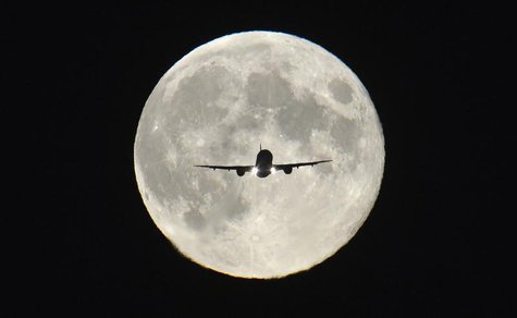 A passenger aircraft, with the full "Harvest Moon" seen behind, makes its final approach to landing at Heathrow Airport in west London, Sept A passenger aircraft, with the full "Harvest Moon" seen behind, makes its final approach to landing at Heathrow Airport in west London, Sept