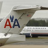A US Airways plane passes American Airlines planes at Ronald Reagan National Airport in Washington April 23, 2012. REUTERS/Kevin Lamarque A US Airways plane passes American Airlines planes at Ronald Reagan National Airport in Washington April 23, 2012. REUTERS/Kevin Lamarque