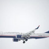 A US Airways Embraer ERJ-190 jet descends for landing at Philadelphia International Airport in Philadelphia, Pennsylvania on December 9, 201 A US Airways Embraer ERJ-190 jet descends for landing at Philadelphia International Airport in Philadelphia, Pennsylvania on December 9, 201