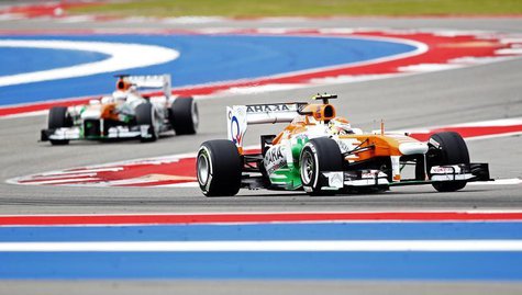 Force India Formula One driver Adrian Sutil of Germany (R) and Force India Formula One driver Paul di Resta of Britain drive during the thir Force India Formula One driver Adrian Sutil of Germany (R) and Force India Formula One driver Paul di Resta of Britain drive during the thir