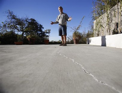 Homeowner Gary Gless looks at cracks in cement in his backyard in Los Angeles, California December 11, 2013. REUTERS/Mario Anzuoni Homeowner Gary Gless looks at cracks in cement in his backyard in Los Angeles, California December 11, 2013. REUTERS/Mario Anzuoni