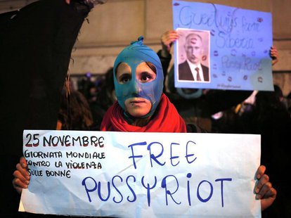 A demonstrator holds a placard supporting Pussy Riot in front of Quirinale palace in Rome, as Russia's President Vladimir Putin visits his I A demonstrator holds a placard supporting Pussy Riot in front of Quirinale palace in Rome, as Russia's President Vladimir Putin visits his I