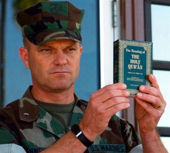 File photo of Michael Lehnert holding a copy of the Koran as he announced that they had arrived and were distributed to detainees at Camp X- File photo of Michael Lehnert holding a copy of the Koran as he announced that they had arrived and were distributed to detainees at Camp X-