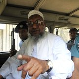 Bangladesh's Jamaat-e-Islami leader Abdul Quader Mollah gestures as he talks from a police van after a war crimes tribunal sentenced him to Bangladesh's Jamaat-e-Islami leader Abdul Quader Mollah gestures as he talks from a police van after a war crimes tribunal sentenced him to
