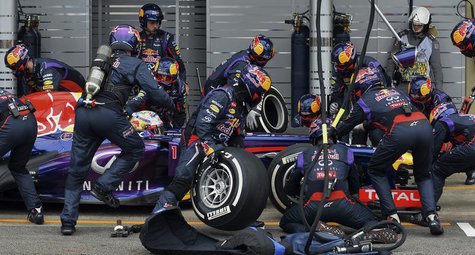 Red Bull Formula One driver Sebastian Vettel of Germany is attended to by his crew during a pit stop during the Brazilian F1 Grand Prix at t Red Bull Formula One driver Sebastian Vettel of Germany is attended to by his crew during a pit stop during the Brazilian F1 Grand Prix at t