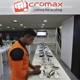 An employee stands at the counter of Micromax mobile phones at a showroom in New Delhi December 6, 2013. REUTERS/Adnan Abidi An employee stands at the counter of Micromax mobile phones at a showroom in New Delhi December 6, 2013. REUTERS/Adnan Abidi