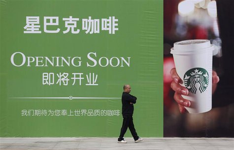 A man walks past an advertisement board of Starbucks in Wuhan, Hubei province, in this October 29, 2013 file photo. REUTERS/Stringer A man walks past an advertisement board of Starbucks in Wuhan, Hubei province, in this October 29, 2013 file photo. REUTERS/Stringer