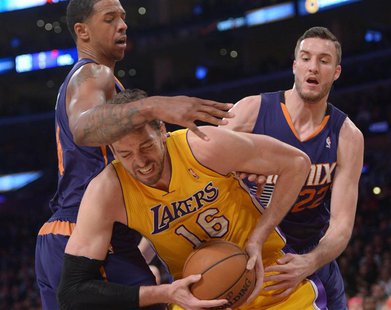 Los Angeles Lakers forward Pau Gasol (16) is defended by Phoenix Suns forward Channing Frye (8) and center Miles Plumlee (22) at Staples Cen Los Angeles Lakers forward Pau Gasol (16) is defended by Phoenix Suns forward Channing Frye (8) and center Miles Plumlee (22) at Staples Cen