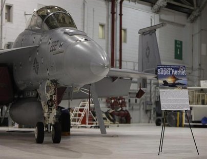 A F/A 18 E/F Super Hornet fighter jet is seen in its hanger during ceremonies celebrating the 35th anniversary of the F/A18 Hornet fighter j A F/A 18 E/F Super Hornet fighter jet is seen in its hanger during ceremonies celebrating the 35th anniversary of the F/A18 Hornet fighter j