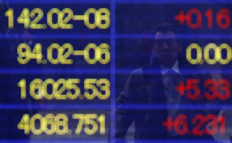A pedestrian is reflected in an electronic board showing exchange rates between the Japanese yen against the euro (top L to bottom), the yen A pedestrian is reflected in an electronic board showing exchange rates between the Japanese yen against the euro (top L to bottom), the yen