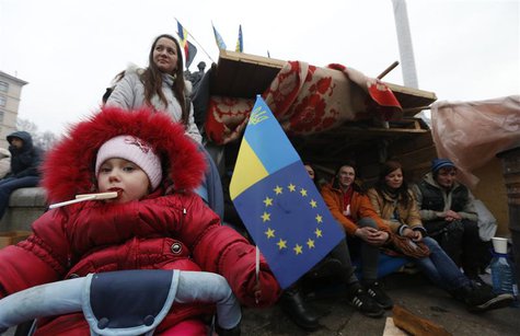 A child holds a flag during a rally held by Pro-European integration protestors in Independence Square in central Kiev, December 13, 2013. R A child holds a flag during a rally held by Pro-European integration protestors in Independence Square in central Kiev, December 13, 2013. R