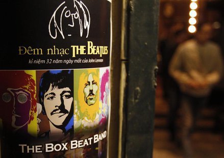 A fan walks near a poster promoting a tribute concert which marks the 32nd death anniversary of British legendary rocker John Lennon of the A fan walks near a poster promoting a tribute concert which marks the 32nd death anniversary of British legendary rocker John Lennon of the
