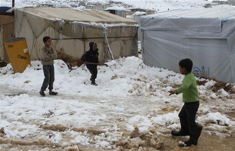 A Syrian refugee child shovels snow outside a tent in Aarsal town in Lebanon's eastern Bekaa December 13, 2013. REUTERS/Ahmad Shalha A Syrian refugee child shovels snow outside a tent in Aarsal town in Lebanon's eastern Bekaa December 13, 2013. REUTERS/Ahmad Shalha