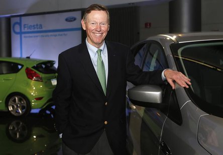 Ford Motor Co. CEO Alan Mulally poses next to a Ford vehicle during a gathering with members of the media at the Ford Conference Center in D Ford Motor Co. CEO Alan Mulally poses next to a Ford vehicle during a gathering with members of the media at the Ford Conference Center in D
