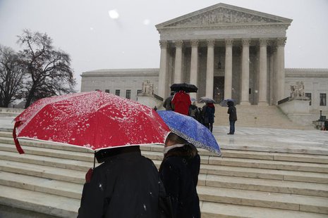 A light snow falls as visitors gather on the steps of the U.S. Supreme Court in Washington, December 10, 2013. REUTERS/Jonathan Ernst A light snow falls as visitors gather on the steps of the U.S. Supreme Court in Washington, December 10, 2013. REUTERS/Jonathan Ernst