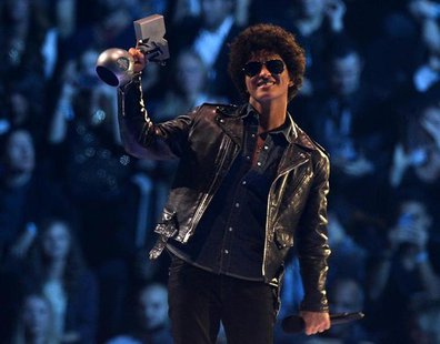 Singer Bruno Mars reacts after receiving his trophy during the 2013 MTV Europe Music Awards at the Ziggo Dome in Amsterdam November 10, 2013 Singer Bruno Mars reacts after receiving his trophy during the 2013 MTV Europe Music Awards at the Ziggo Dome in Amsterdam November 10, 2013