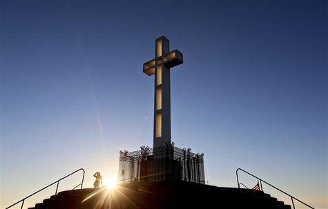 People gather in the late evening sun around the massive cross sitting atop the Mt. Soledad War Memorial in La Jolla, California on December People gather in the late evening sun around the massive cross sitting atop the Mt. Soledad War Memorial in La Jolla, California on December