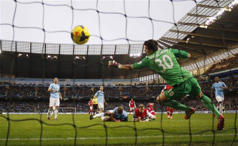 Arsenal's Per Mertesacker (C, bottom) heads and scores a goal during their English Premier League soccer match against Manchester City at th Arsenal's Per Mertesacker (C, bottom) heads and scores a goal during their English Premier League soccer match against Manchester City at th