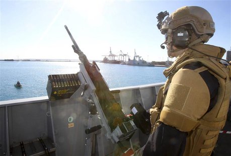 A member of the Norwegian Special Forces stands guard on a frigate, which is part of a joint Norwegian-Danish task force planning to assist A member of the Norwegian Special Forces stands guard on a frigate, which is part of a joint Norwegian-Danish task force planning to assist