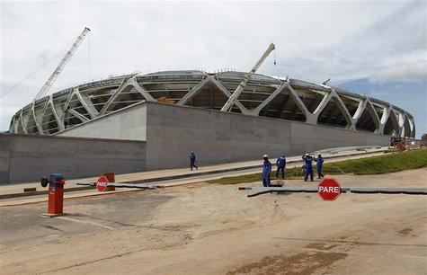 Workers stand outside the Arena Amazonia stadium under construction to host several 2014 World Cup soccer games, in Manaus December 14, 2013 Workers stand outside the Arena Amazonia stadium under construction to host several 2014 World Cup soccer games, in Manaus December 14, 2013