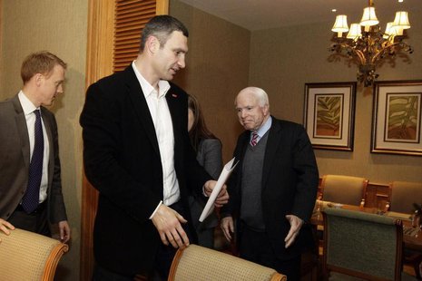 U.S. Senator John McCain (R) reacts as Ukrainian opposition leader Vitaly Klitschko (C) looks on, during their meeting in Kiev December 14, U.S. Senator John McCain (R) reacts as Ukrainian opposition leader Vitaly Klitschko (C) looks on, during their meeting in Kiev December 14,
